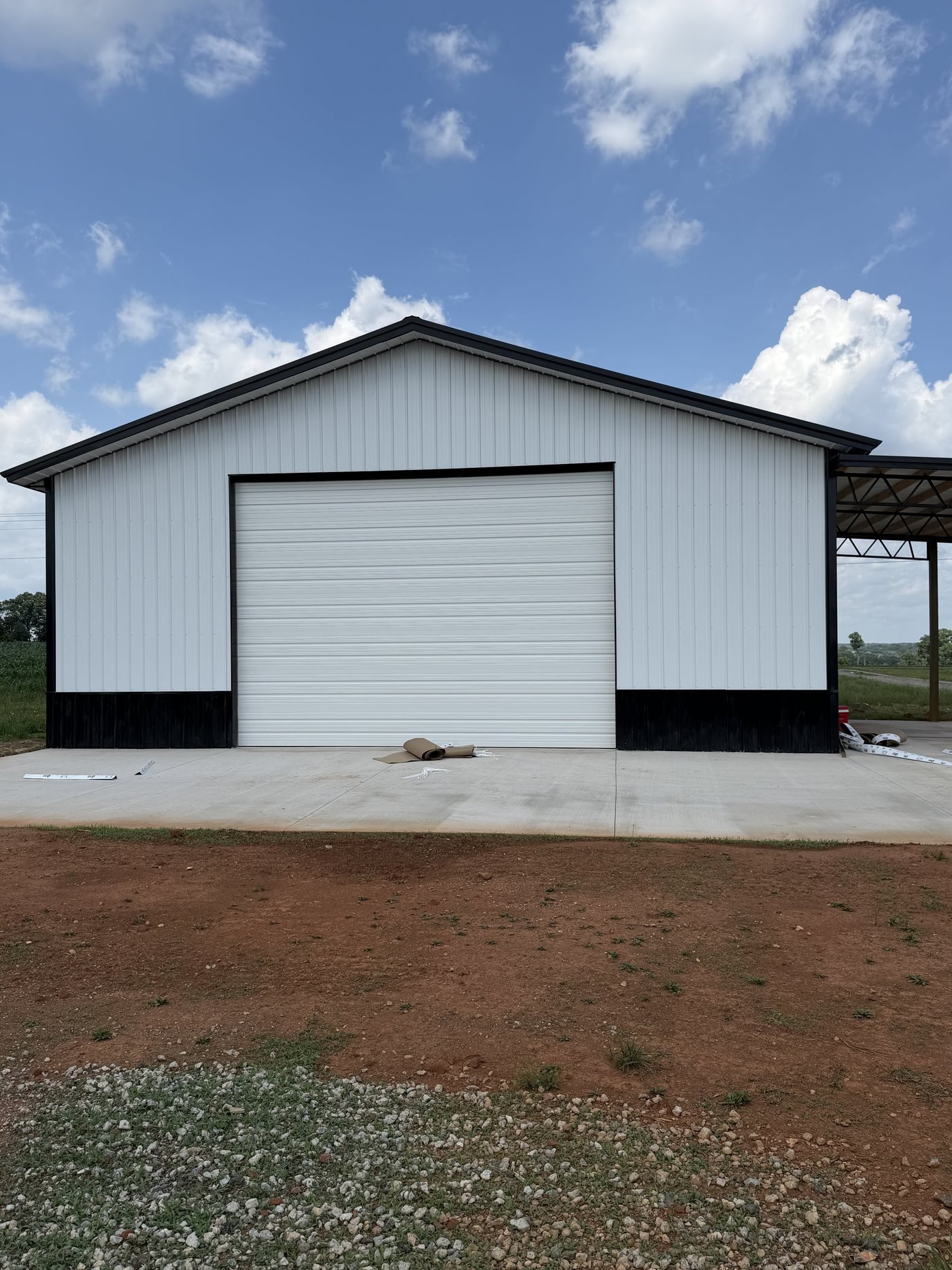Oversized white commercial garage door installed on a steel building
